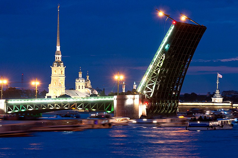 Raised 'wings' of Palace (Dvortsovy) Bridge and tour boats on Neva River in St Petersburg, Russia